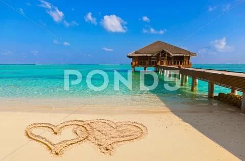 Drawing connected hearts on beach Stock Photos