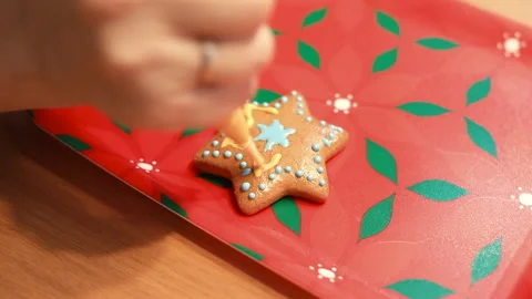 Drawing with cream on the cookie. Make a pattern on food. Stock Footage 145550345