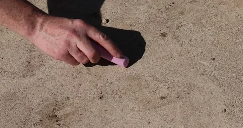 Drawing different elements on a concrete road with colorful children's crayons, 스톡 동영상 323774547