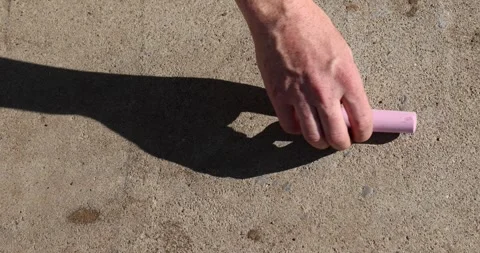 Drawing different elements on a concrete road with colorful children's crayons, Stock Footage 325703338
