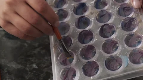 Drawing a dye with a brush for sweets in the form. Stock Footage 132865754