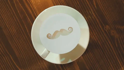 Drawing on the foam of coffee or latte art in the form of a mustache close Stock-Footage 100641174