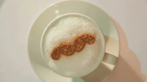 Drawing on the foam of coffee or latte art in the form of a mustache close Stock-Footage 101431223