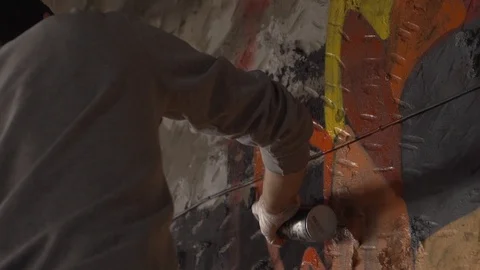 Drawing graffiti with red paint on the wall Stock Footage 122151388