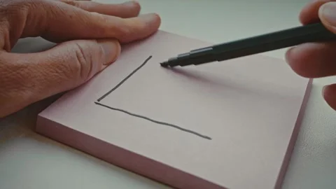 Drawing a graph with a negative trend arrow and question mark meaning decline Stock Footage 288965668