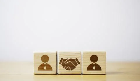 Drawing of hand shaking which print screen on wooden cube block in front of.. Stock Photos