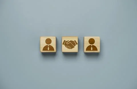 Drawing of hand shaking which print screen on wooden cube block in front of.. Stock Photos