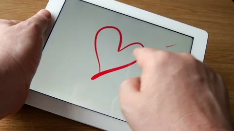 Drawing heart with arrow on tablet computer, 4K, UHD Stock Footage 49305372