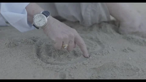 Drawing heart in beach sand Stock Footage 300158102