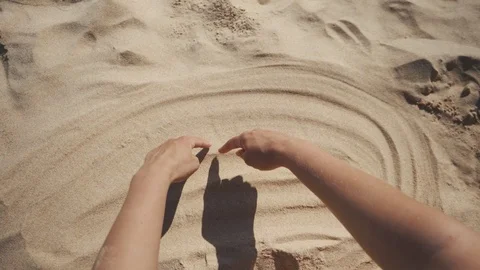 Drawing heart on the sand on the beach Stock Footage