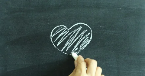 Drawing heart shape on chalkboard Video stock 107755951