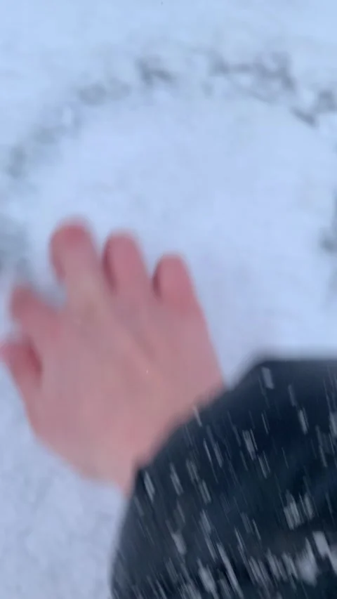 Drawing Heart Shape on Snow with Finger Stock Footage 328107035
