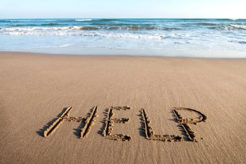 Drawing HELP on the sand Stock Photos