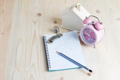 Drawing a house on the notebook Stock Photos