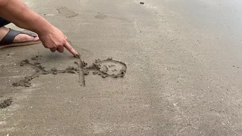Drawing a human in the beach sand Stock Footage 287824347