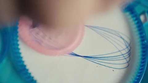 Drawing a Hypotrochoid Figure Using a Spirograph Stock Footage 313822125