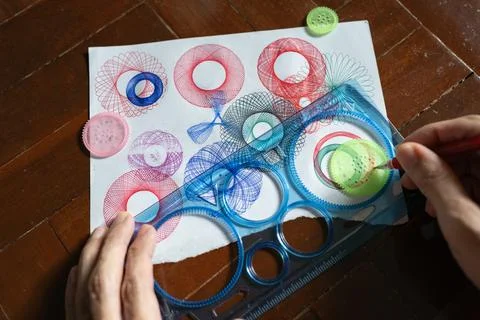 Drawing a Hypotrochoid Figures Using a Spirograph Stock Photos