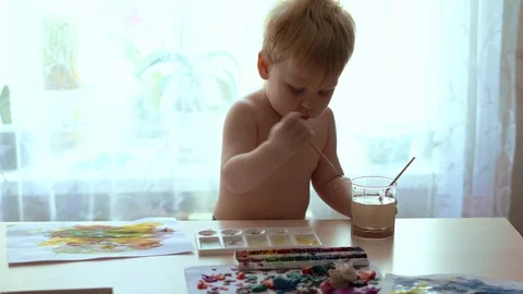 Drawing kid stares when you increase the brightness of the light Stock Footage 128817446