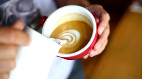 Drawing Latte Art on Coffee with Soy Milk. Process of Making latte art. 動画素材 334650144
