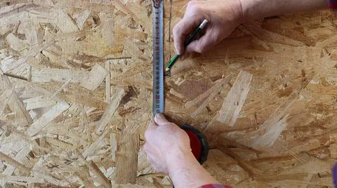 Drawing a line on an OSB sheet Stock Photos