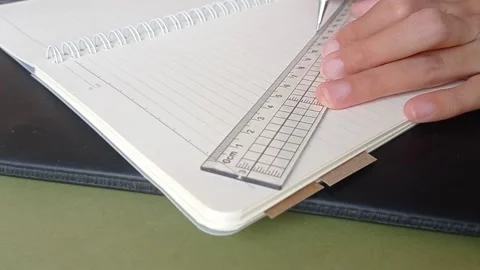 Drawing a line on the paper for finishing the task Stock Footage 150523471