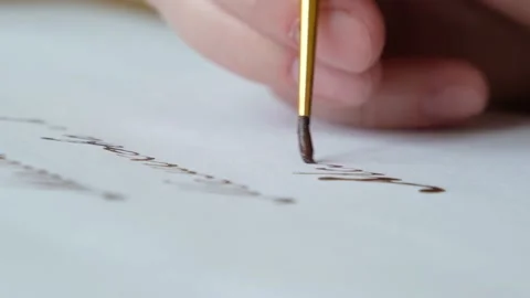 Drawing lines on white paper with brush macro shot Stock Footage 133268959