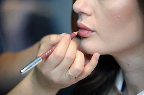 Drawing lips contours on a face Stock Photos
