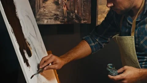 Drawing a man in an apartment in the evening, a creative hobby of the artist Video stock 156085392