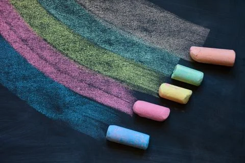 Drawing multicolor lines with colorful chalks on blackboard Stock Photos