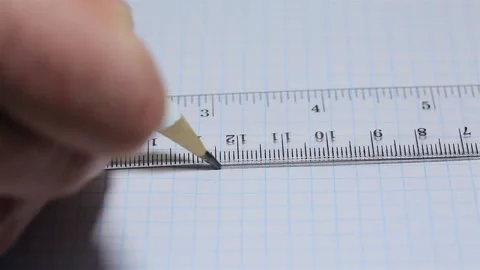 Drawing in a notebook with a pencil under a ruler Stock Footage 250760415