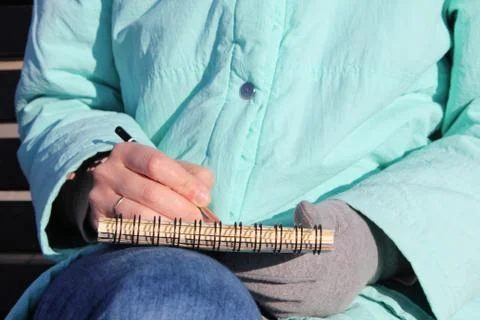 Drawing in a notebook on the waterfront Stock Photos