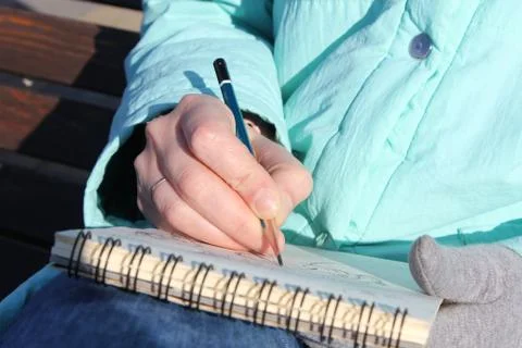 Drawing in a notebook on the waterfront Stock Photos