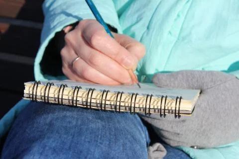 Drawing in a notebook on the waterfront Stock Photos