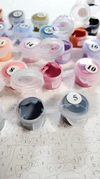 Drawing by numbers. Selective focus. The acrylic paints in the drawing kit have Stock Photos