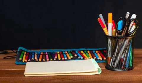 Drawing pad on the table with colored pencils on the table. Stock Photos