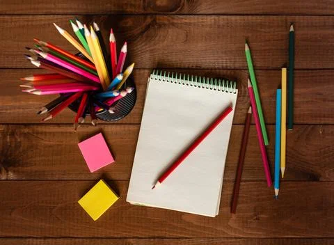 Drawing pad on the table with colored pencils on the table. Stock Photos