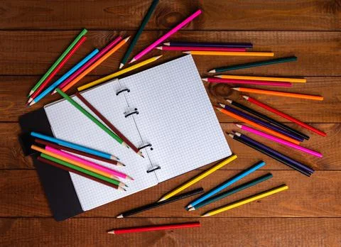 Drawing pad on the table with colored pencils on the table. Stock Photos