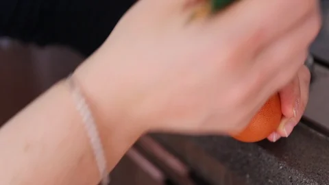 Drawing patterns with black wax on an egg near a stove by woman hands Stock Footage 128352248