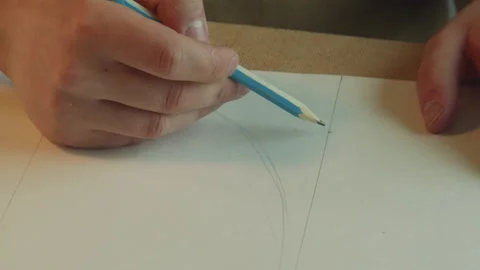 Drawing patterns in pencil on white paper close-up. Concept of work in progress. Stock Footage 143725640