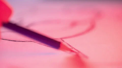 Drawing with pencil red lighting extra close up Stock-Footage 158621141