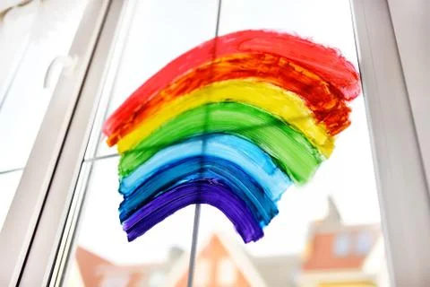 Drawing of rainbow on home window while coronavirus quarantine. Sign rainbow  Stock Photos