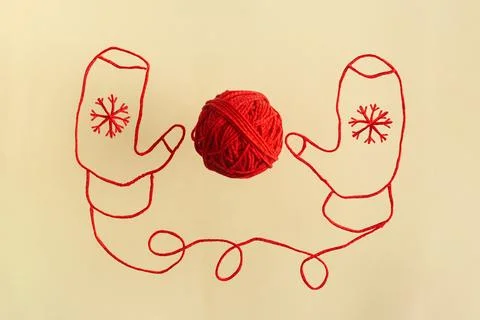 Drawing of red mittens from wool threads with ball integrated knitting and Stock Photos