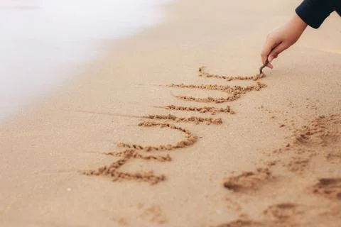 Drawing on sand beach. Stock Photos