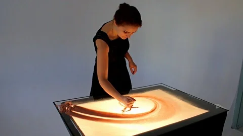 Drawing with sand. Drawing sand on a screen. Sand Artist. Hands draws. Animation Stock Footage 89832459