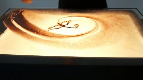 Drawing with sand. Drawing sand on a white screen. Sand Artist. Hands draws Stock Footage 89652886