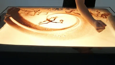Drawing with sand. Drawing sand on a white screen. Sand Artist. Hands draws Stock Footage 89652938