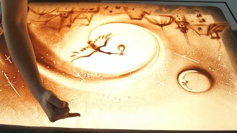 Drawing with sand. Drawing sand on a white screen. Sand Artist. Hands draws Stock Footage 89652992
