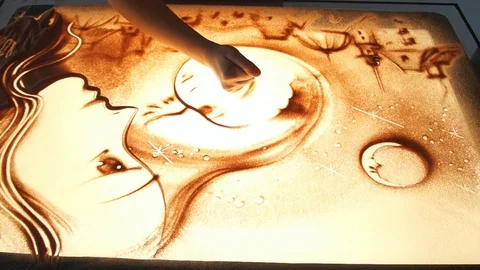Drawing with sand. Drawing sand on a white screen. Sand Artist. Hands draws Stock Footage 89686406