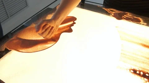 Drawing with sand. Drawing sand on a white screen. Sand Artist. Hands draws Stock Footage 89695340