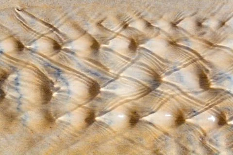 Drawing on the sand made by a stream. Stock Photos